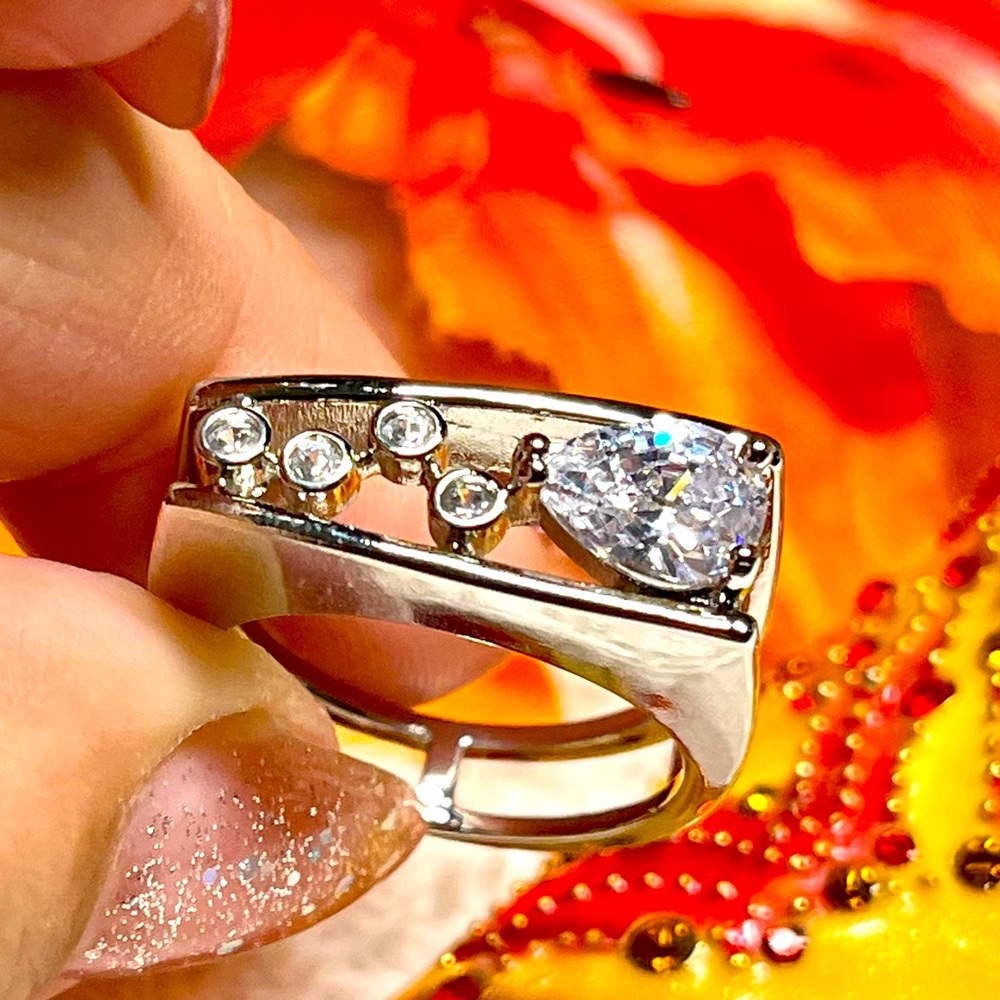 Really unique abstract /geometric ring band style bezel set and pear